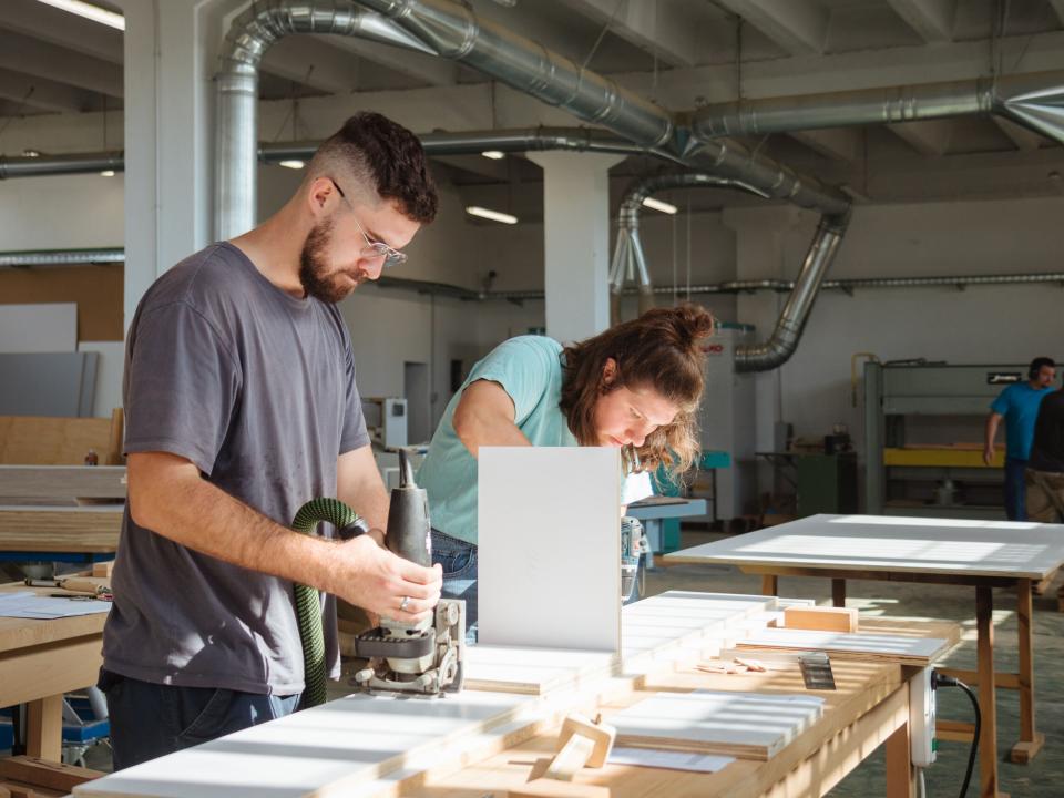 Vlore, Albania :: Noah Caissie (Canada) and Miranda McIntyre (USA) build cabinets in a carpentry work shop.