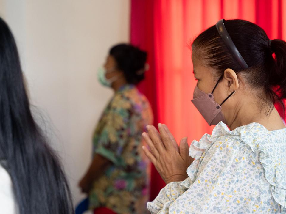 Local believers bow their heads in prayer at a Thai church in southern Thailand. Photo by RJ Rempel.