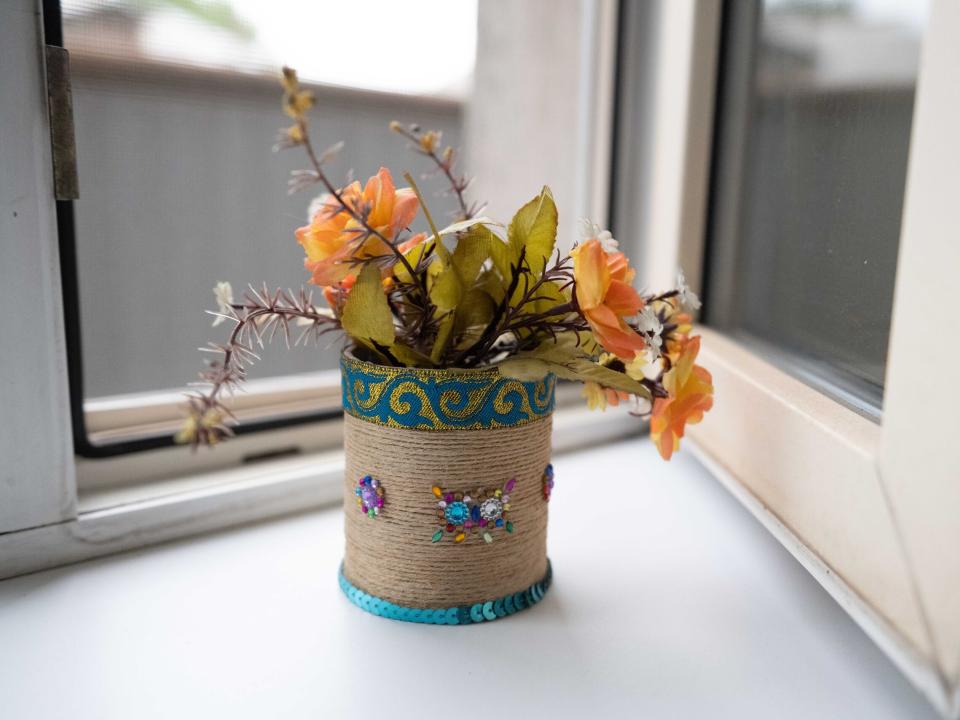 General view of a flowers in a decorative pot on a window sill.