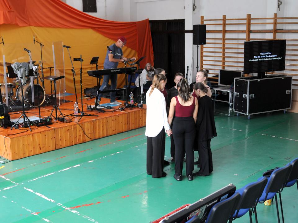 Dancers on the Bill Drake Band Hope Tour in Hungary pray before the performance. Photo by Photo-guy / Guy Williams.