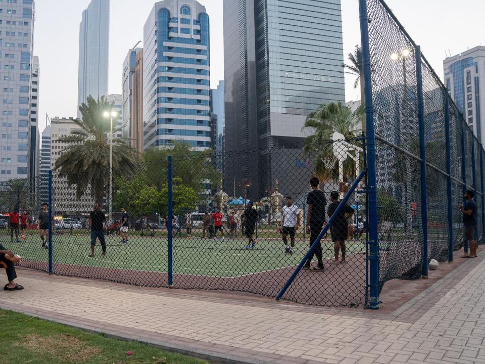 People play football at a park in Abu Dhabi, United Arab Emirates. Photo by RJ Rempel.