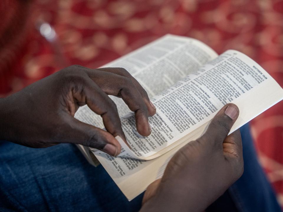 A man flips through the Bible. Photo by RJ Rempel.