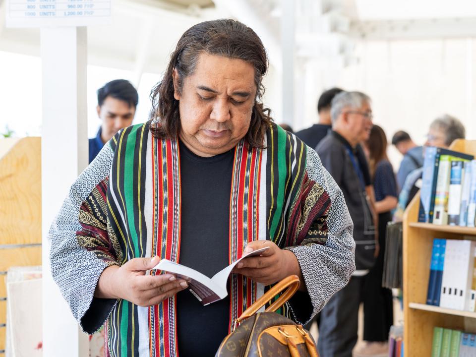 Subic Bay, Philippines :: Guest browses through books after the opening ceremony.
