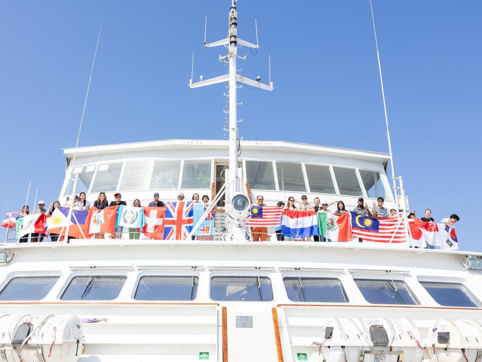 San Fernando, Philippines :: Crewmembers with flags on the outer deck ready for the arrival into port.