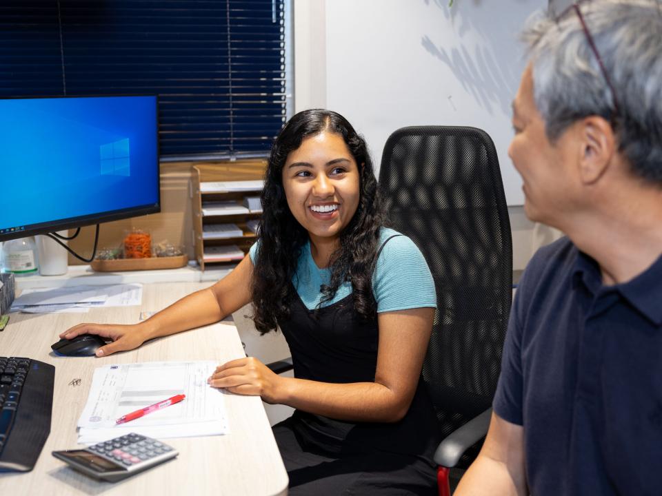 A woman from Mexico discusses work with a man from South Korea. Photo by RJ Rempel.