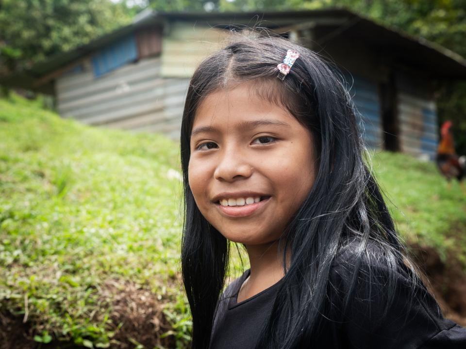 A girl smiles for a photo. Photo by RJ Rempel.