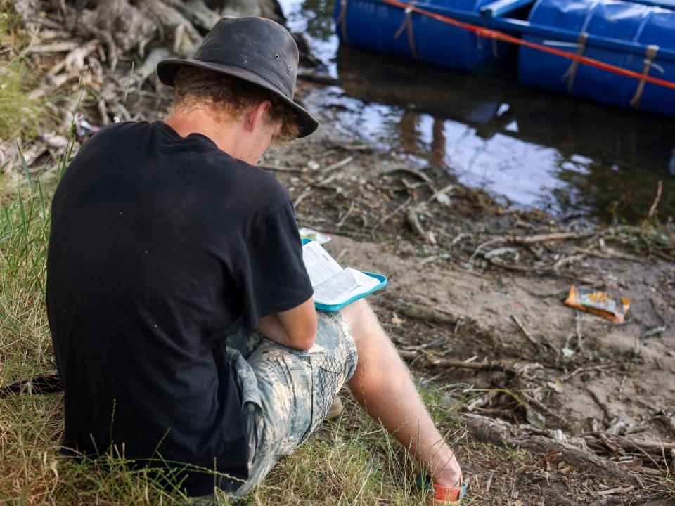 A short term volunteer reading the Bible during a quiet moment at the River Adventure outreach in Moldova. Photo by Jordan Wilkinson.