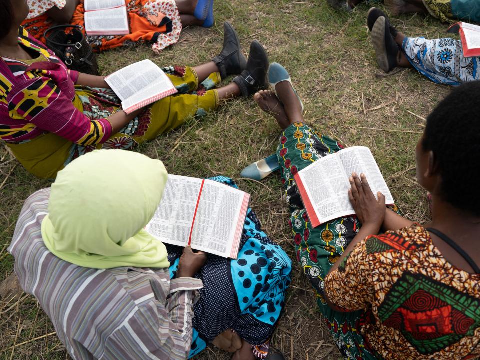 A small group of women from an impoverished community in Southern Europe, gather together for a bible study.