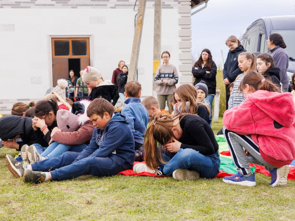 Children pray during a children's program. Photo by Jordan Wilkinson.