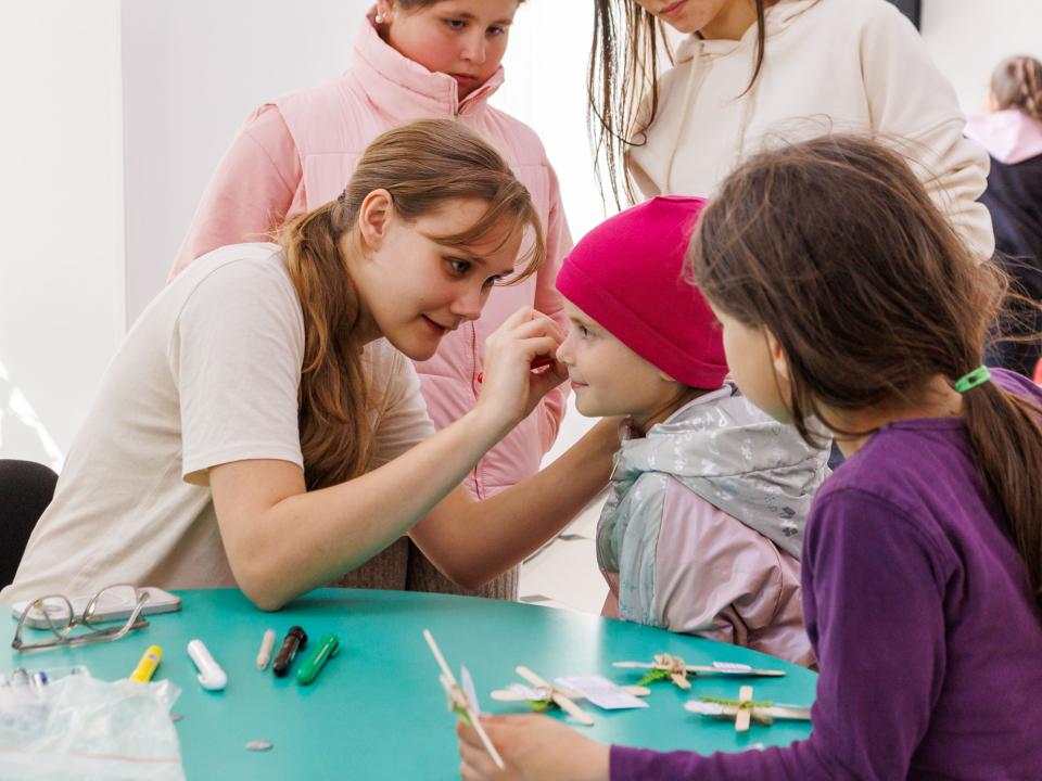 A short-termer paints a child's face during a children's program. Photo by Jordan Wilkinson.