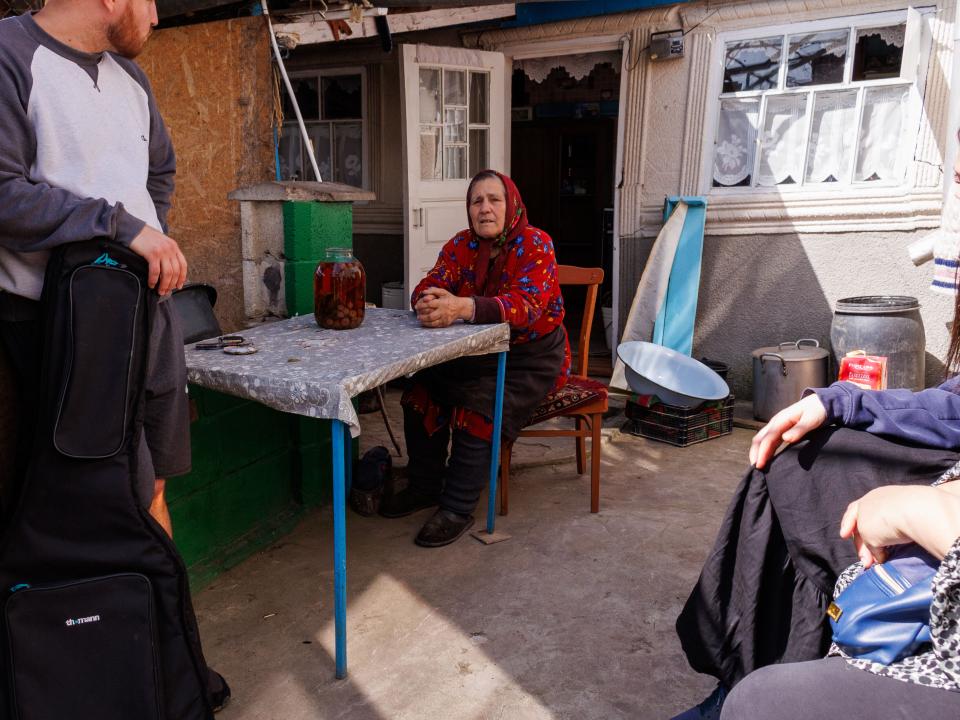 A short-term team and OM team members visits an elderly woman in her home. Photo by Jordan Wilkinson.
