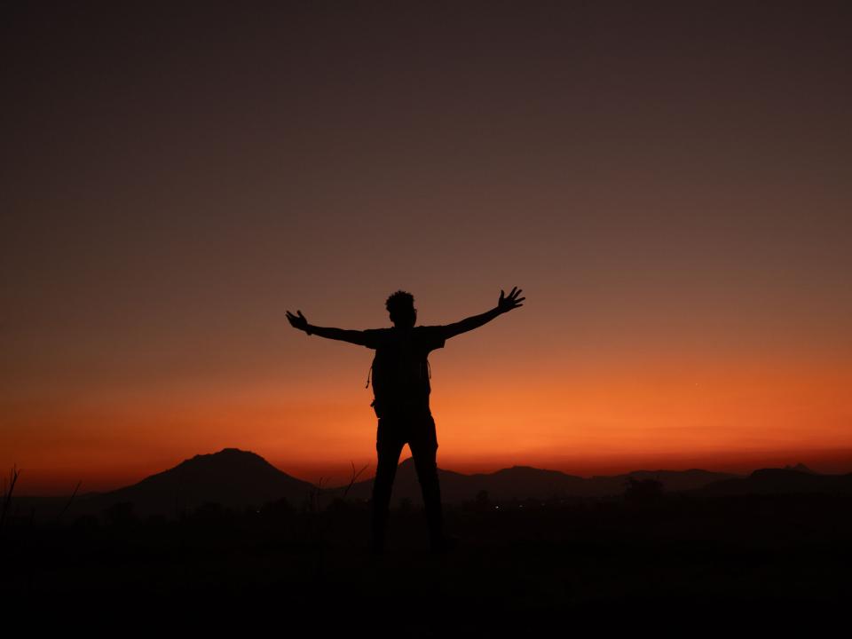 A silhouetted figure at sunset in Malawi. Photo by Ellyn Schellenberg.