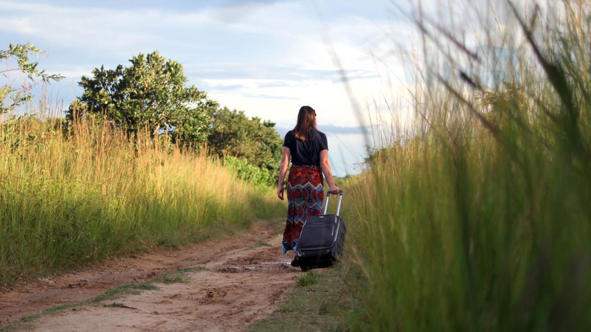 young woman walking with suitcase