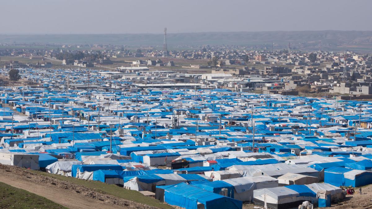 Temporary camp for refugees and Internally Displaced Peoples (IDPs) fills the valley with white tents and blue tarps. Photo by Andrew W. 
Photo by Andrew W.