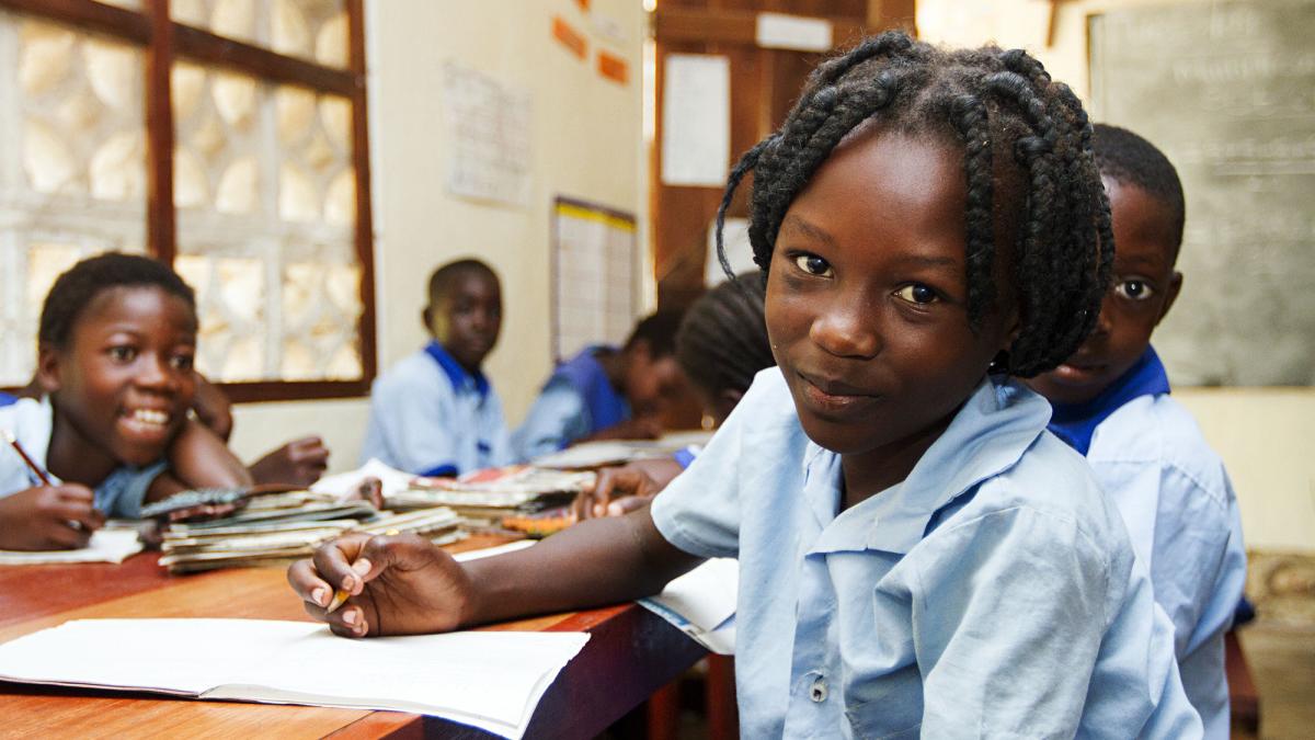 A student looks up from her work at the Good News School II for orphaned and vulnerable children in Mpulungu, Zambia.