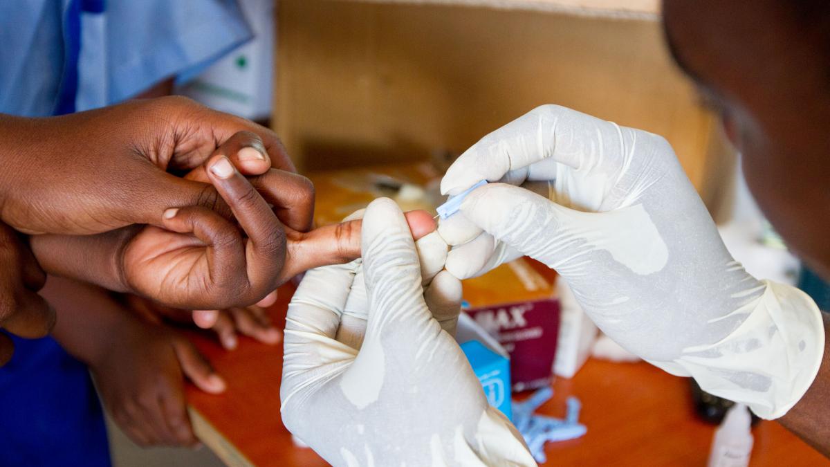 A government health care worker tests a student for HIV at The Good News II School at OM Lake Tanganyika.