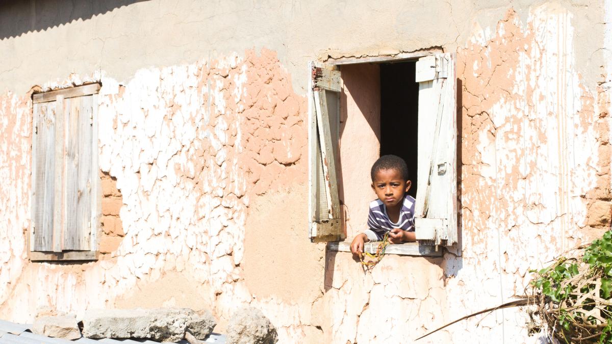 A boy looks out his window in Antananarivo, Madagascar.