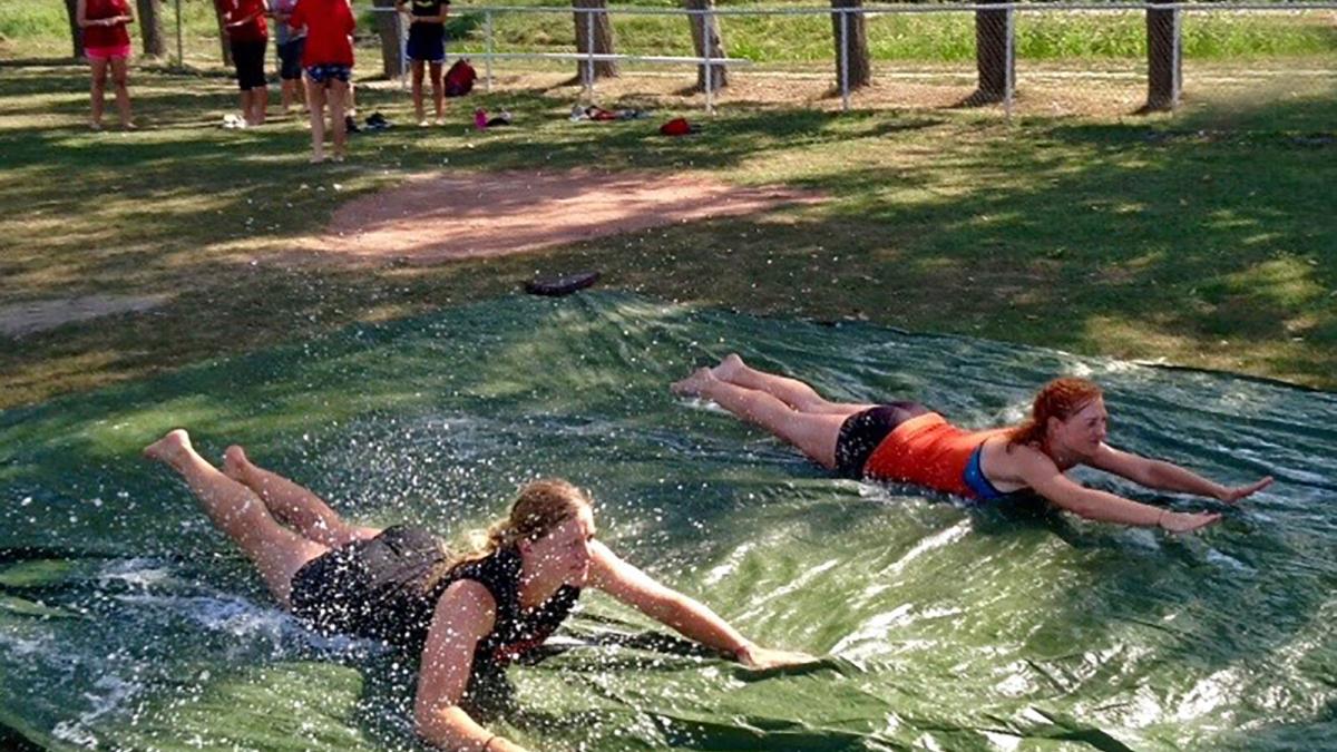 American coaches and Hungarian softball players enjoy a slip-n-slide during a softball camp put on by OM and FCA in summer 2017.