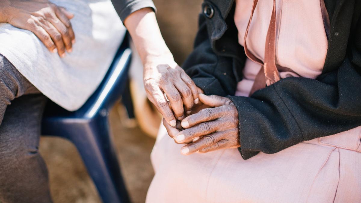 A woman offers her hand in comfort at an outreach in South Africa. Photo by Doseong Park.