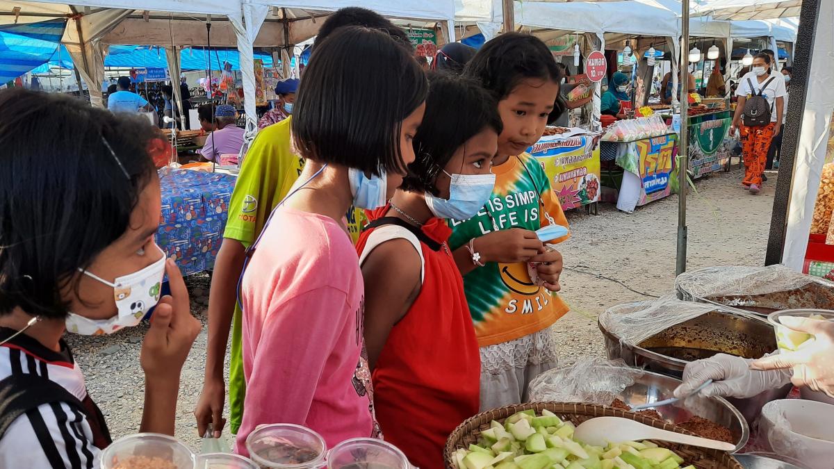 Ryan takes a group of kids to the market in Thailand.