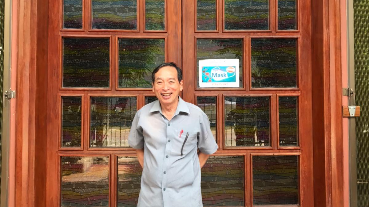 Pastor Winit stands in front of Immanuel Baptist Church, an OM partner committed to obeying Jesus' command to make disciples.