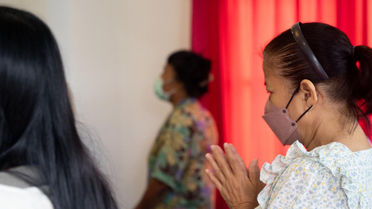 Local believers bow their heads in prayer at a Thai church in southern Thailand. Photo by RJ Rempel.