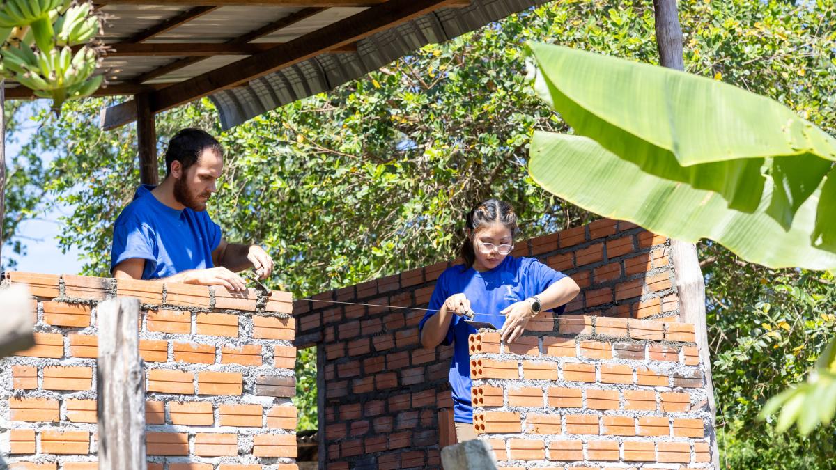 Sihanoukville, Cambodia :: Crewmembers build a house with bricks.