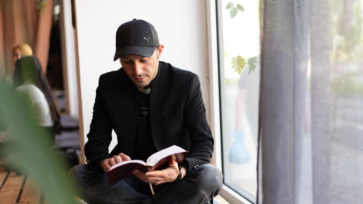 A young man reading the bible. Photo by Achim Schneider