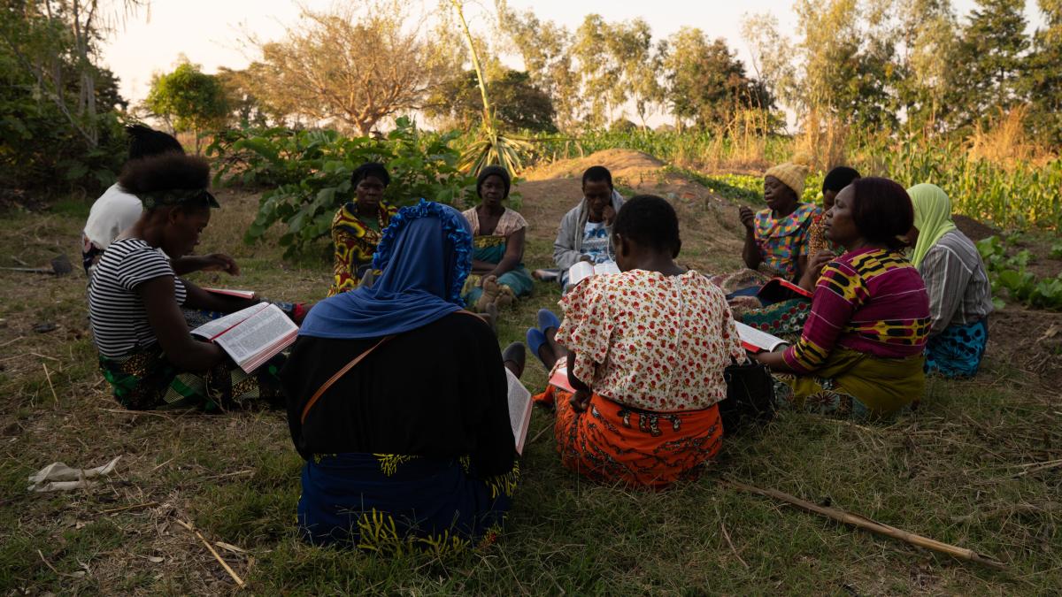 A group of women from an impoverished community in Malawi, gather together for a bible study. They are part of a self-help group that empowers women to help other women.